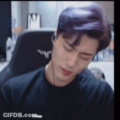 Purple Haired Man Sitting In Chair With Headphones GIF