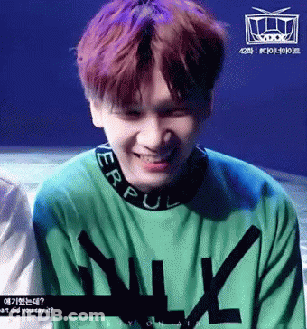 Purple Haired Man Smiling In Green N Sweater GIF