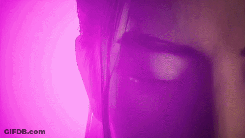 Purple-Lit Woman Face Close-Up GIF