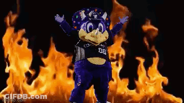 Purple Mascot In Front Of Flames GIF