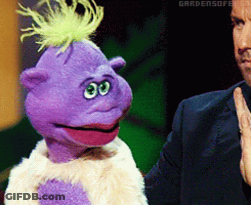 Purple Puppet With Green Mohawk Next To Man In Suit GIF