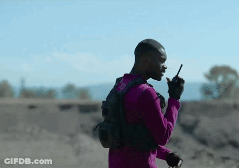 Purple Shirt Man Talking On Walkie Talkie Desert GIF