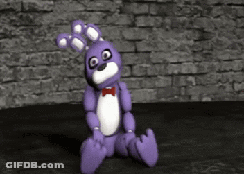 Purple Teddy Bear Sitting In Front Of Brick Wall GIF