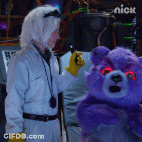 Purple Teddy Bear With Red Eyes Held By Woman In Lab Coat GIF