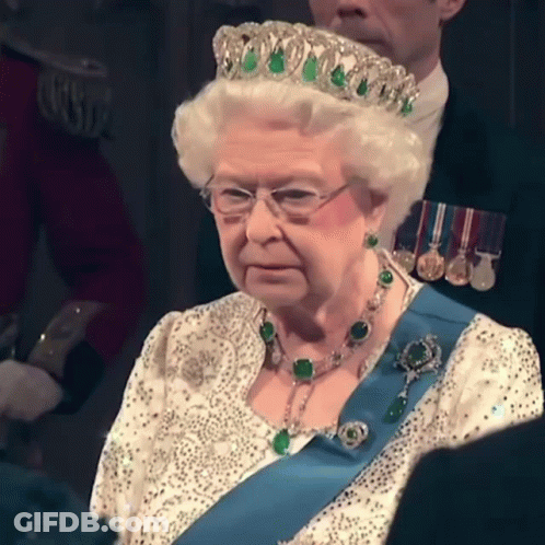 Queen Elizabeth Is Wearing A Tiara And A Blue Sash GIF
