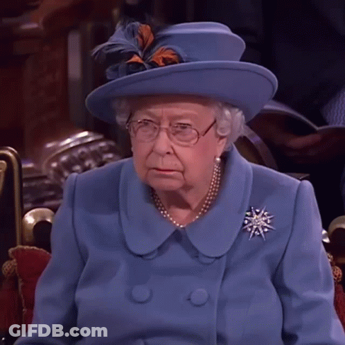 Queen Elizabeth Wearing A Blue Coat And Hat With Feathers GIF