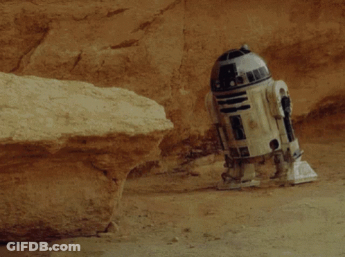 R2D2 Laying In Dirt Near Rock GIF