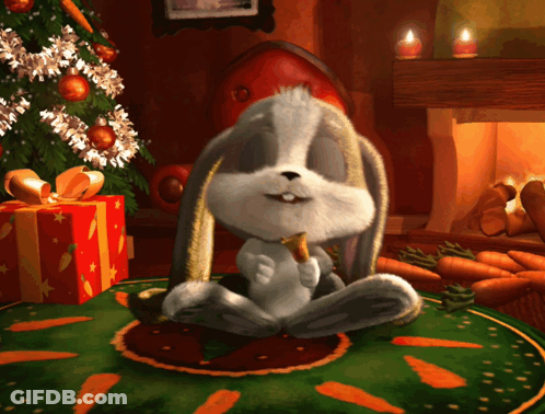 Rabbit Sitting On Rug With Carrots GIF