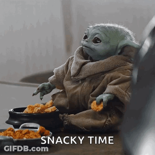 Raccoon Sitting On Wooden Table With Pile Of Food GIF