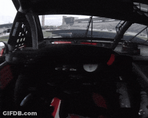 Race Car Dashboard With Red Triangle And Clock GIF