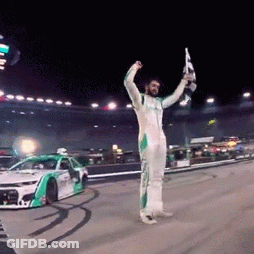 Race Car Driver Holding Trophy And Flag GIF