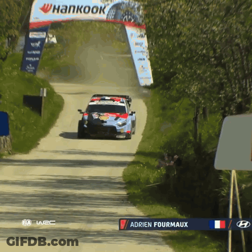 Race Car Driving Down Dirt Road With Hankook Sign GIF