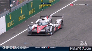 Race Car Driving Down Track With Rolex Advertisement GIF