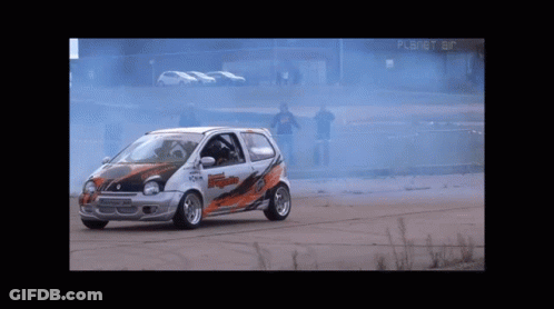 Race Car Driving In Front Of Planet Air Building GIF