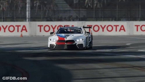 Race Car Driving On Track With Toyota Sign GIF