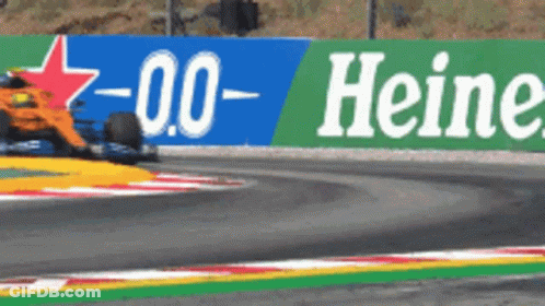 Race Car Driving Past Heineken Sign GIF