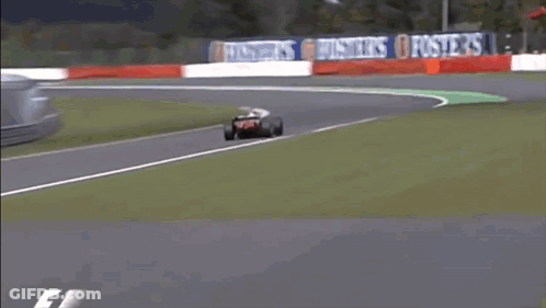 Race Car Going Around Curve With Bridgestone Sign GIF