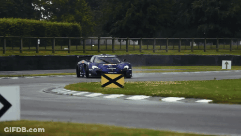 Race Car Going Around Curve With Yellow X GIF