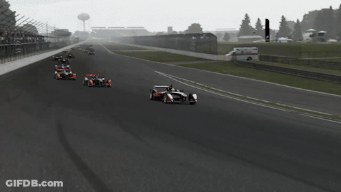 Race Car Going Down Track With Fence GIF