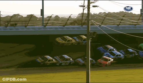 Race Cars Lined Up Under Bridge With Fox Sign GIF