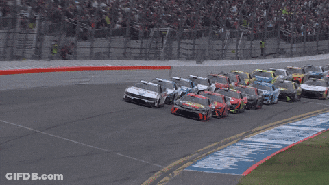 Race Cars On A Track With A 500 Sign In The Background GIF