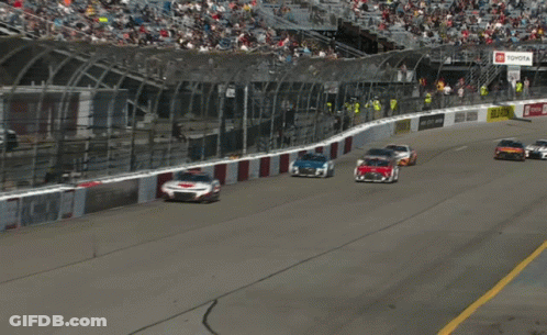 Race Cars Racing Past Yellow DHL Sign GIF