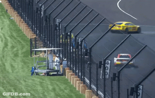 Race Track With Fence And Sign Saying 409 GIF