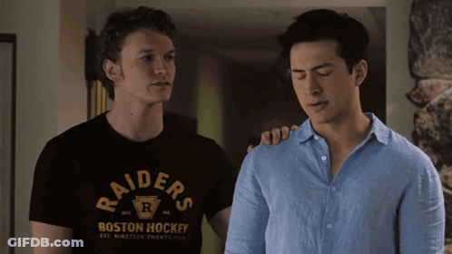 Raiders Shirt Man Next To Blue Shirt Man GIF