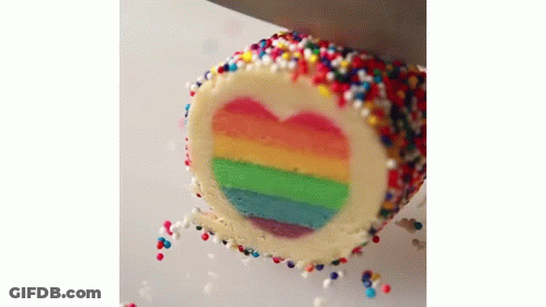 Rainbow Cake With Heart Cut Out And Sprinkles GIF