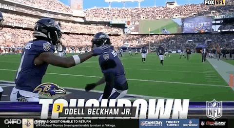 Ravens Players Hugging On Football Field GIF