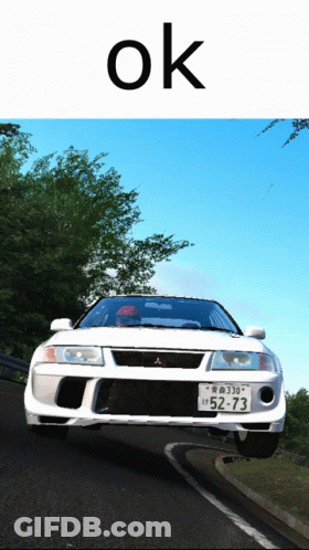 Red And Blue Cars In Front Of Stocktrain Container GIF