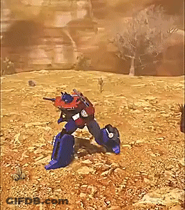 Red And Blue Robot Standing In Desert GIF