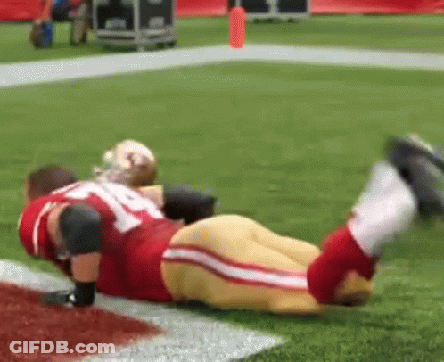 Red And Gold Football Player Lying With Legs Up GIF