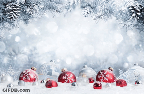 Red And Silver Christmas Ornaments In The Snow With Pine Cones In The Background GIF