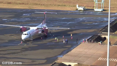 Red And White Airplane On Tarmac GIF