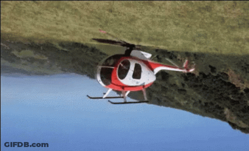 Red And White Helicopter Flying Over Grassy Hill GIF