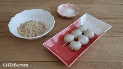 Red And White Plate With Rice Balls On Sticks Next To Rice And Salt Bowls GIF