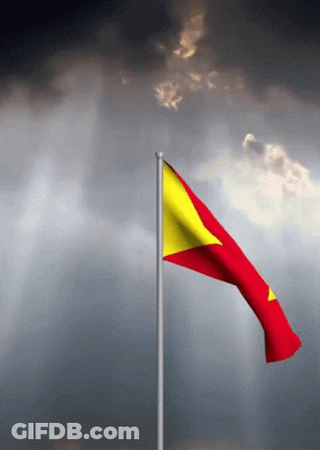 Red And Yellow Flag Waving On Cloudy Sky GIF