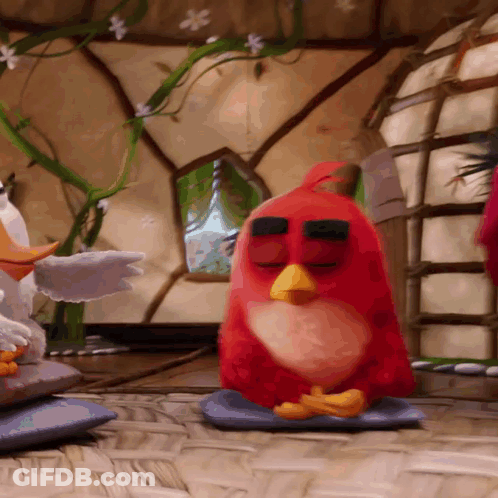 Red Angry Bird Sitting On Blue Pillow With Eyes Closed GIF
