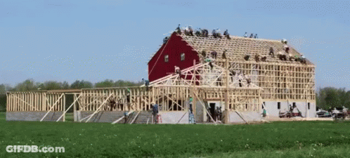 Red Barn Being Built In Field GIF