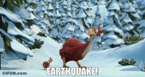 Red Bird Standing In Snow In Front Of Mountain GIF