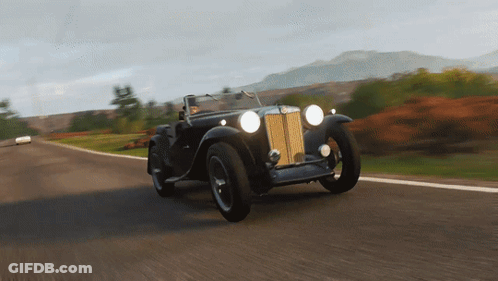 Red BMW Sports Car Driving Down Road GIF