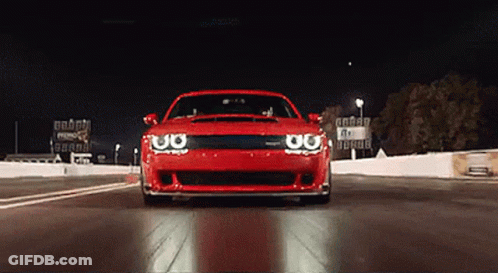 Red Car Driving At Night Sign Saying A GIF