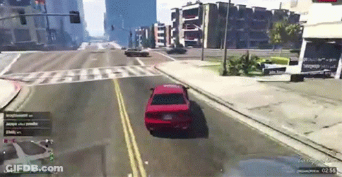 Red Car Driving Down City Street GIF