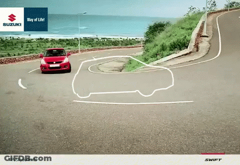Red Car Driving Down Curvy Road With Suzuki Logo GIF
