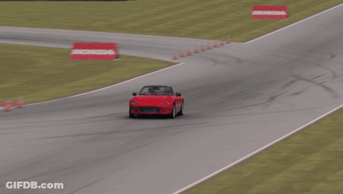 Red Car Driving Down Race Track With Houston Sign GIF