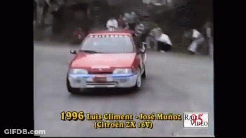 Red Car Driving Down Road With 1996 GIF