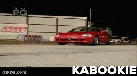 Red Car Driving Down Road With Kabookie GIF