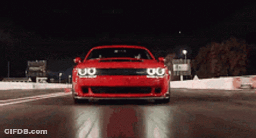 Red Car Driving On Track At Night GIF