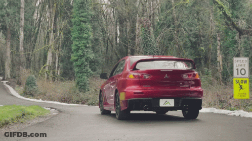 Red Car Driving Past Speed Limit Sign GIF